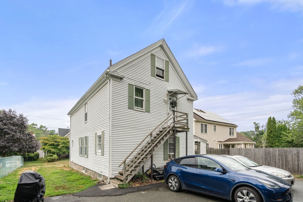 102 Maple Street Needham, MA 02492 - Photo 3 of 7 a front view of a house with parking space