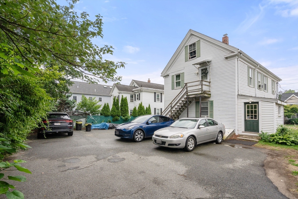 102 Maple Street Needham, MA 02492 - Photo 4 of 7 a car parked in front of a house