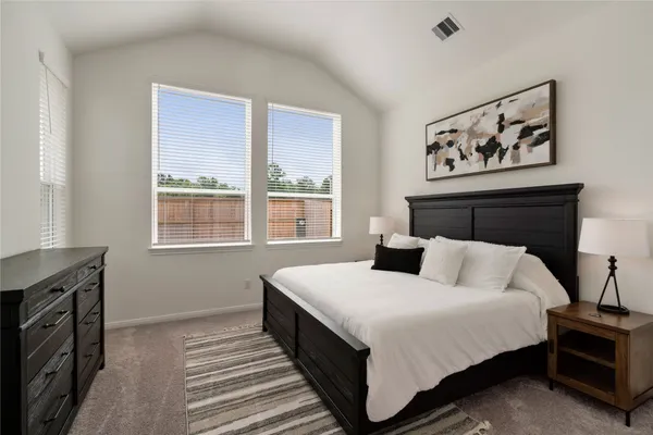 a bedroom with bed and a window