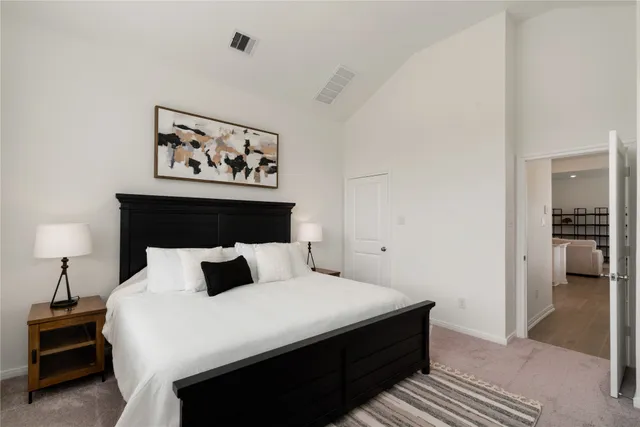 a bedroom with a bed and lamps