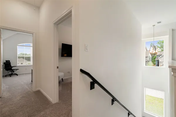 a view of a hallway view with wooden floor and staircase
