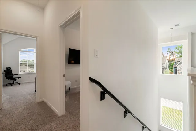 a view of a hallway view with wooden floor and staircase