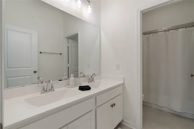 a bathroom with double sink and a mirror