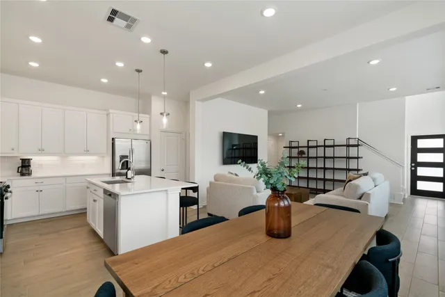 a kitchen with sink and refrigerator