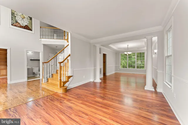a kitchen with stainless steel appliances a sink a stove and wooden floor