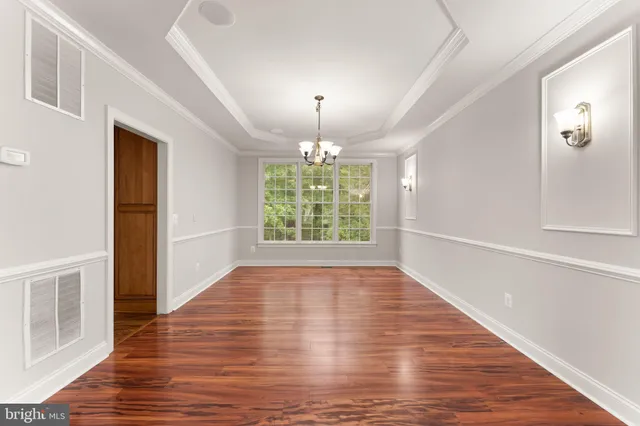 a view of empty room with wooden floor and fireplace