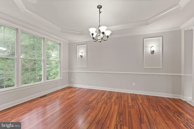 a view of empty room with wooden floor and fireplace
