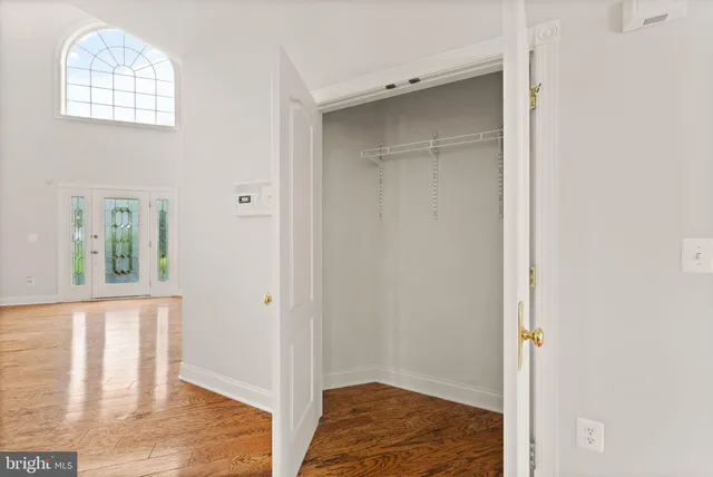 a view of a livingroom with wooden floor and staircase
