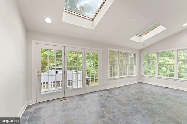 a view of a big room with wooden floor and a window