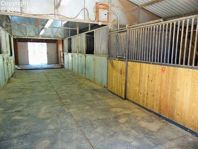 8535 Swan Road Colorado Springs, CO 80908 - Photo 17 of 25 Center Aisle and 4 Stalls Have Mats