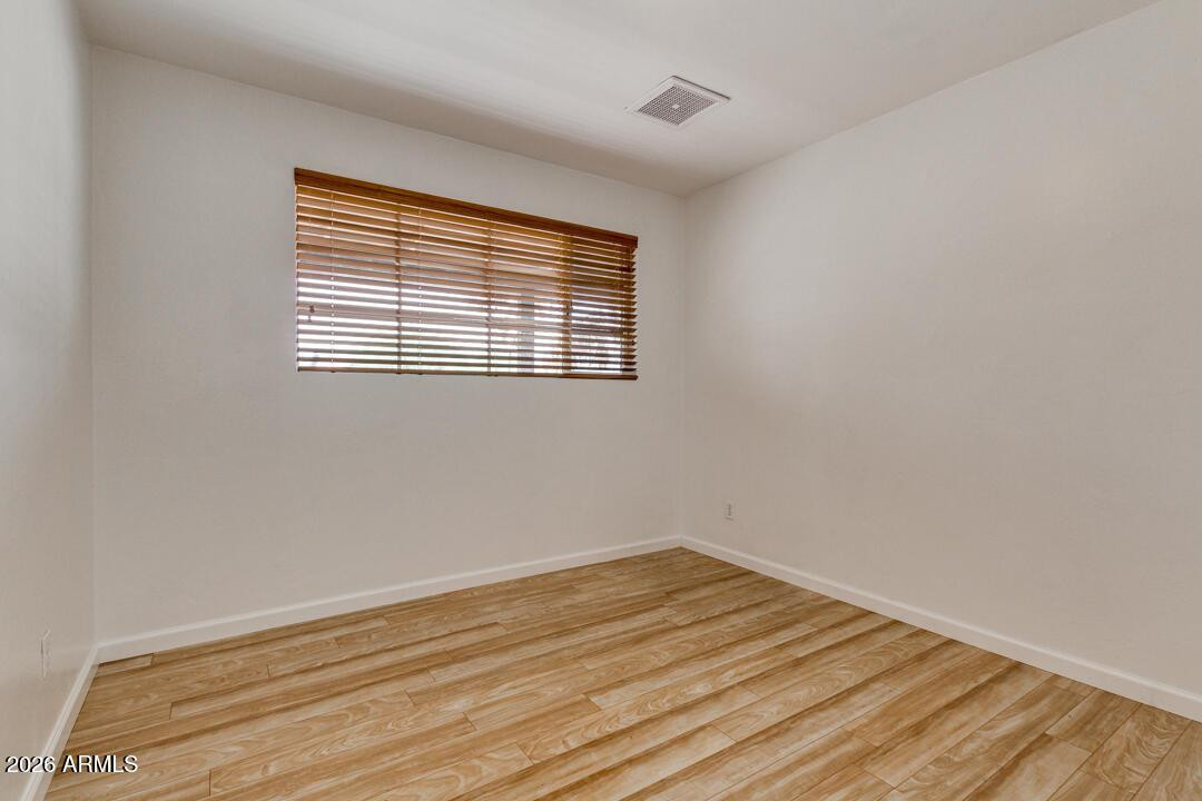 1308 West 6th Street Tempe, AZ 85281 - Photo 11 of 27 a view of empty room with wooden floor and fan