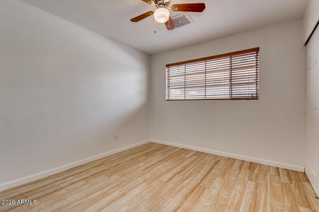 1308 West 6th Street Tempe, AZ 85281 - Photo 18 of 27 an empty room with a window and a ceiling fan