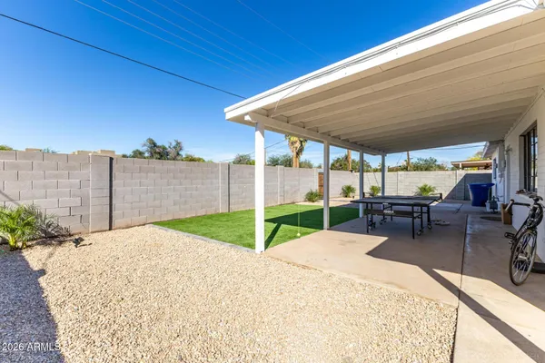 a view of a backyard with sitting area