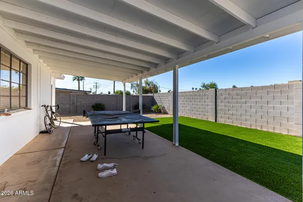 a view of backyard with a table and chairs