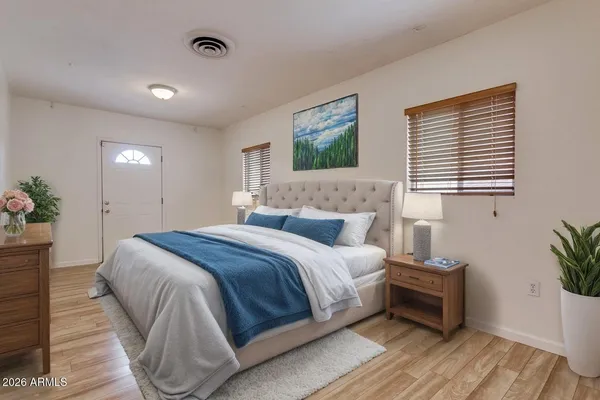 a bedroom with a bed and a potted plant