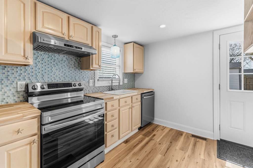 8 Cottage Street Wareham, MA 02571 - Photo 5 of 30 a kitchen with a stove and a microwave