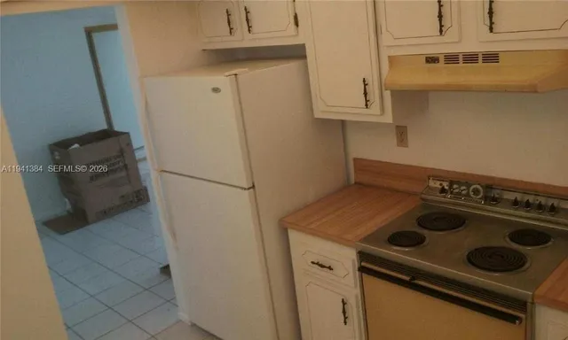 a kitchen with a stove and a refrigerator