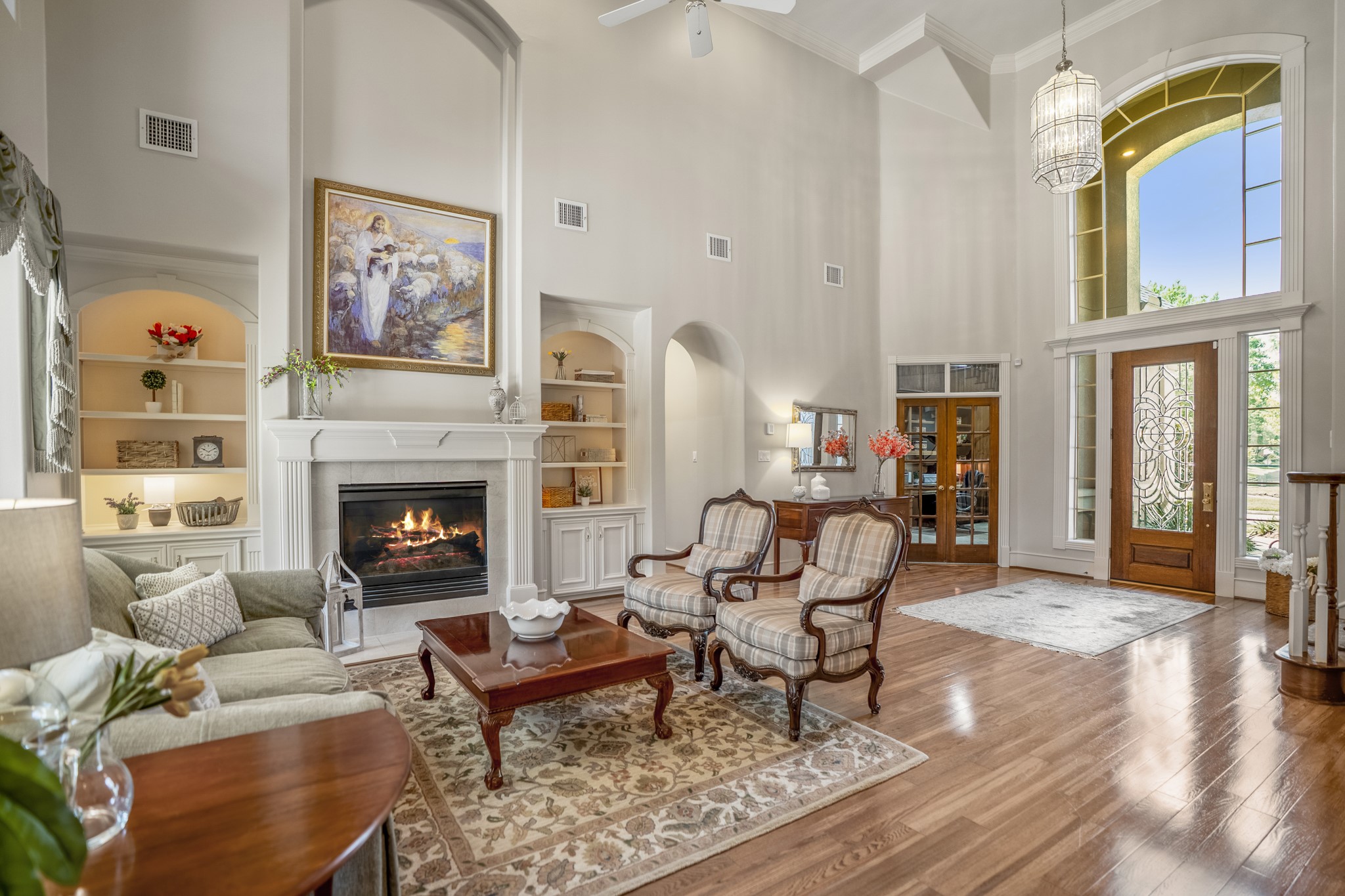 8806 Sterling Gate Circle Spring, TX 77379 - Photo 7 of 40 Two story living room with lots of natural lighting, gas log fireplace and gorgeous wood floors.