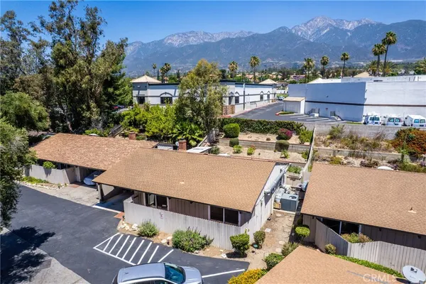 an aerial view of a house with a mountain