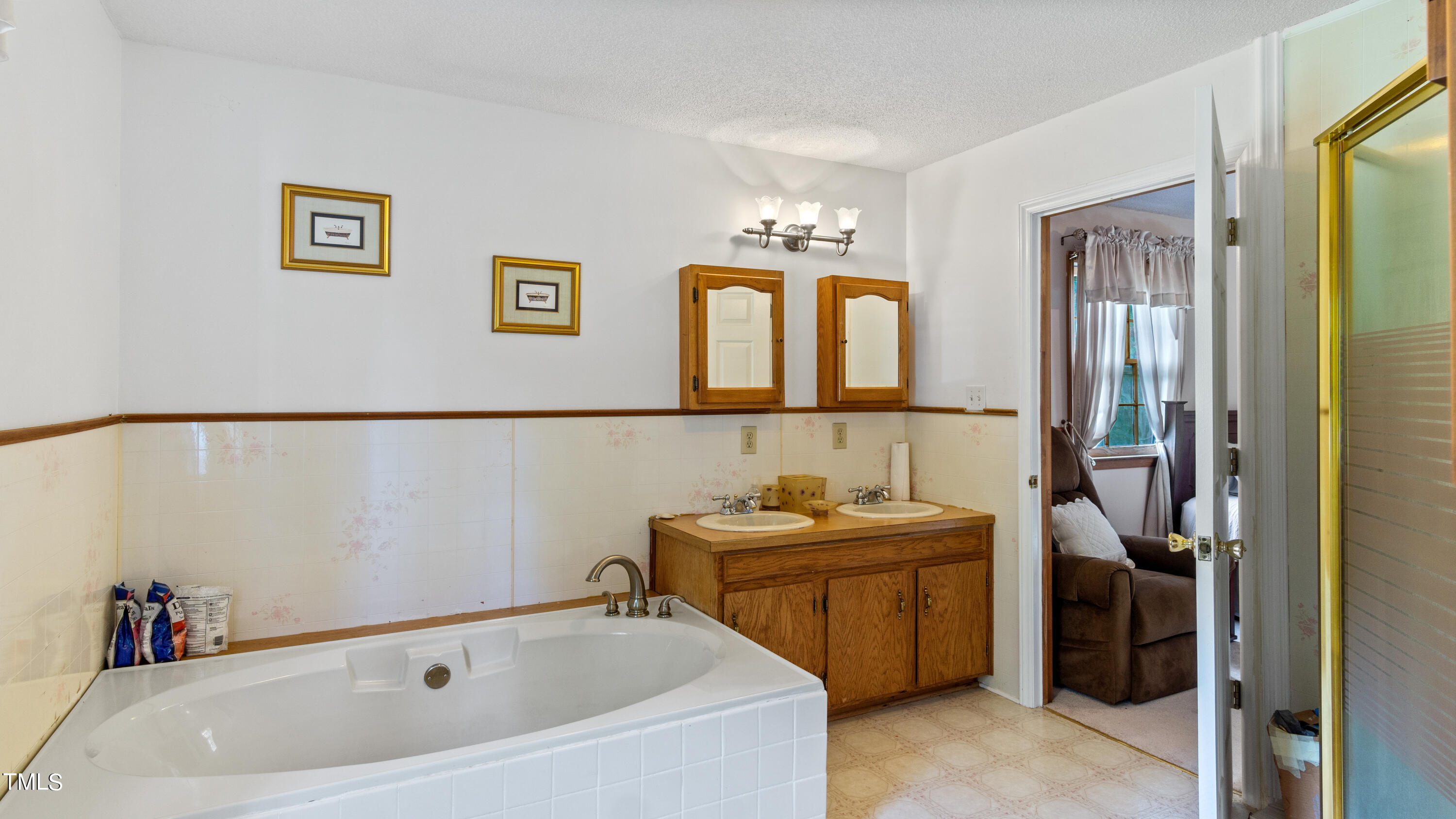 125 Walter Street Manson, NC 27553 - Photo 14 of 39 a bathroom with a tub sink and mirror