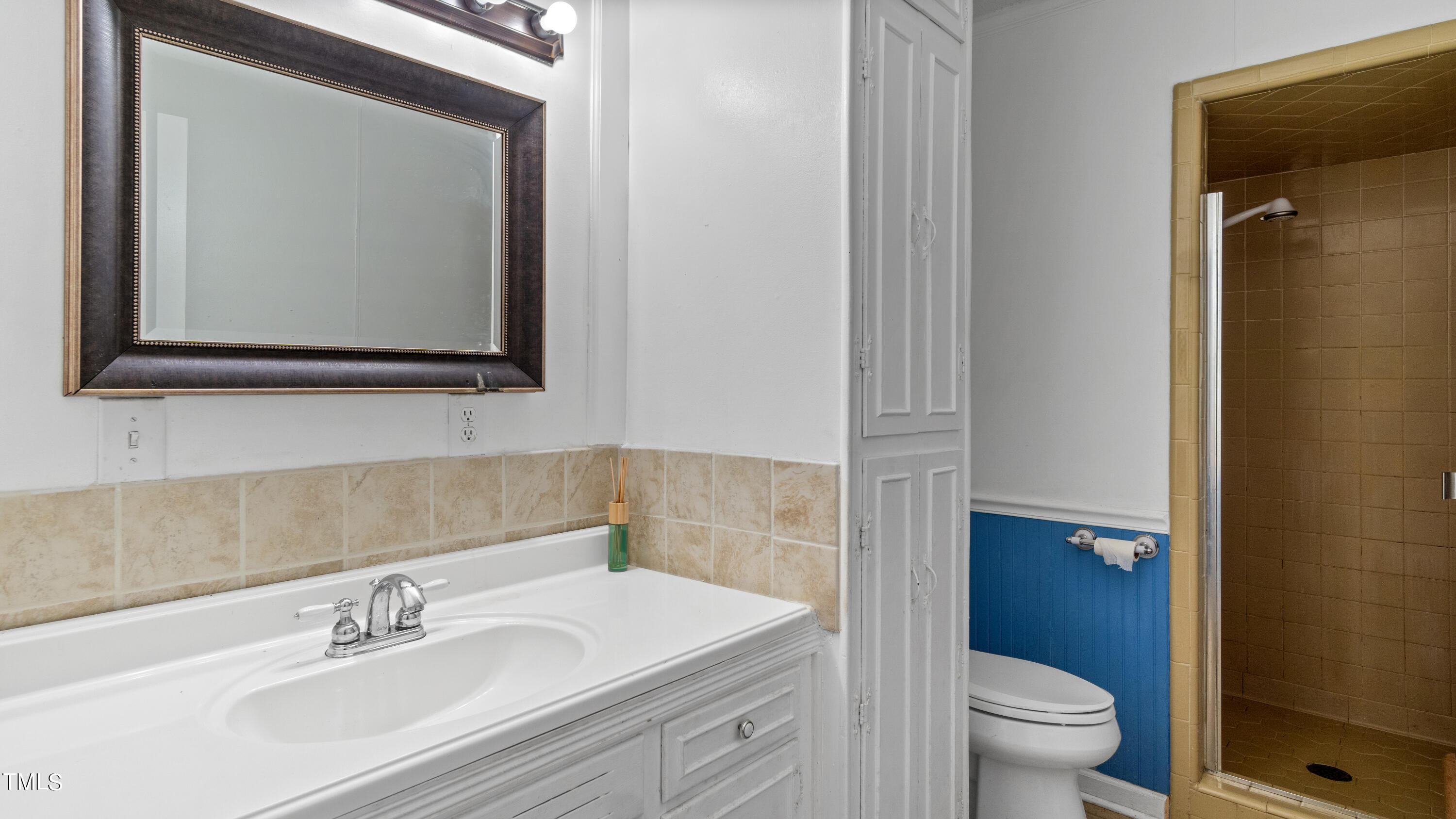 125 Walter Street Manson, NC 27553 - Photo 18 of 39 a bathroom with a toilet a sink a vanity and mirror