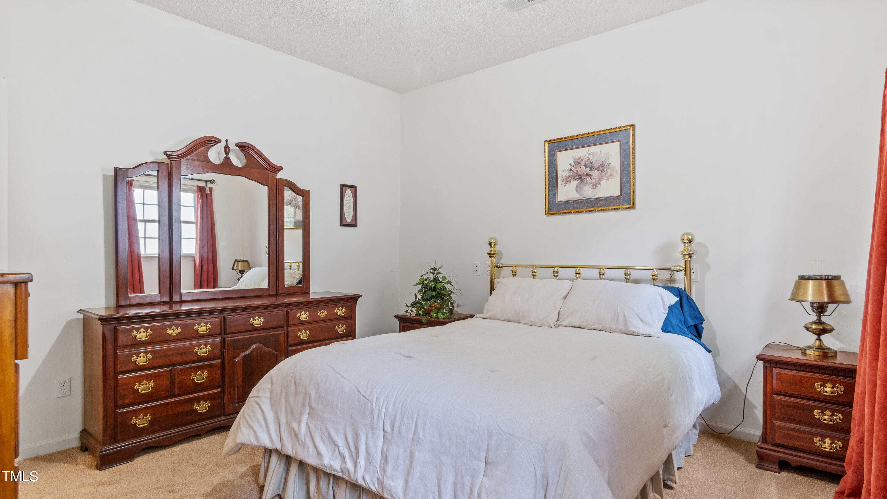 125 Walter Street Manson, NC 27553 - Photo 20 of 39 a bedroom with a bed a dresser and a painting