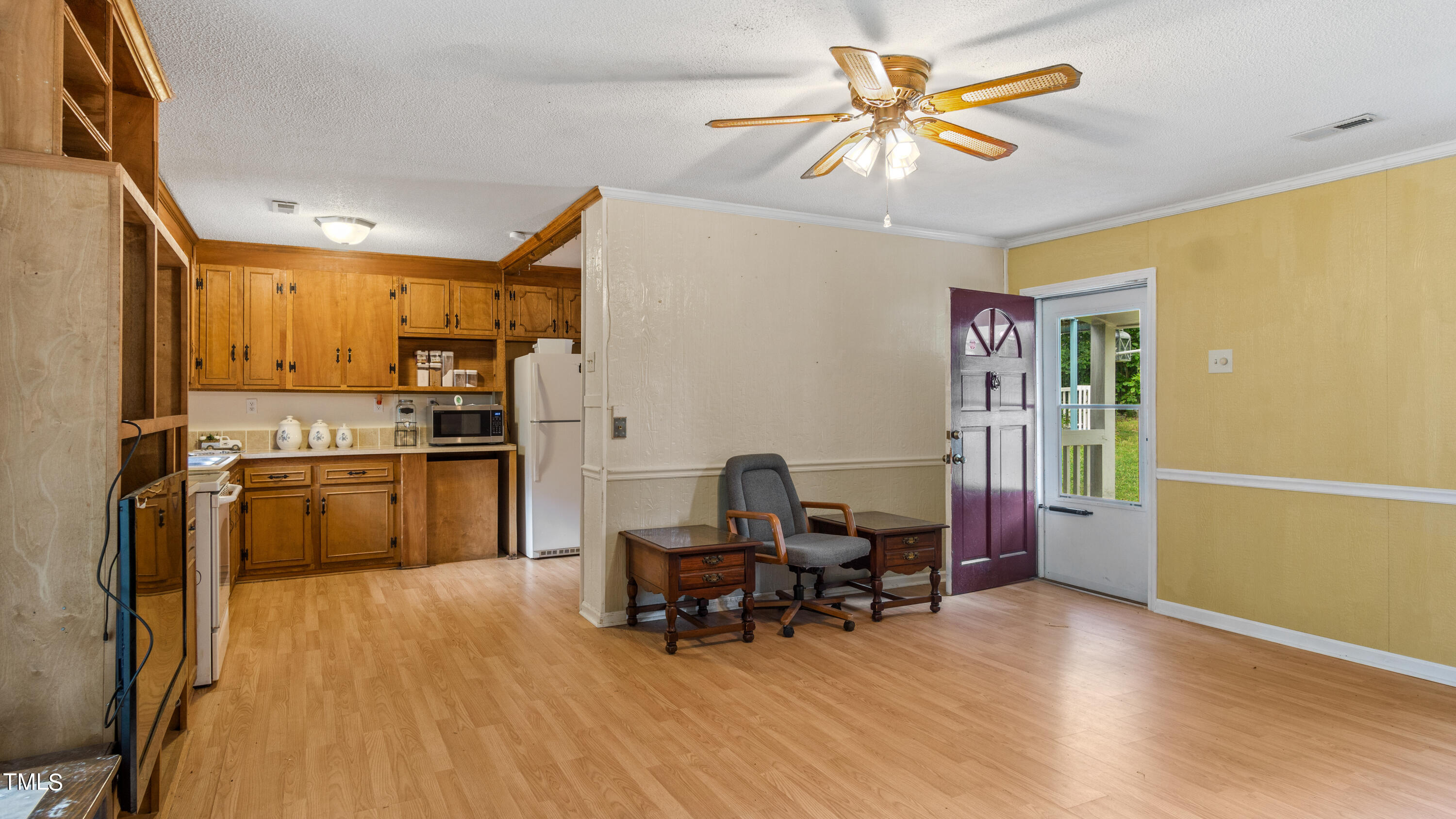 125 Walter Street Manson, NC 27553 - Photo 6 of 39 a kitchen with stainless steel appliances a stove a refrigerator a dining table and chairs with wooden floor