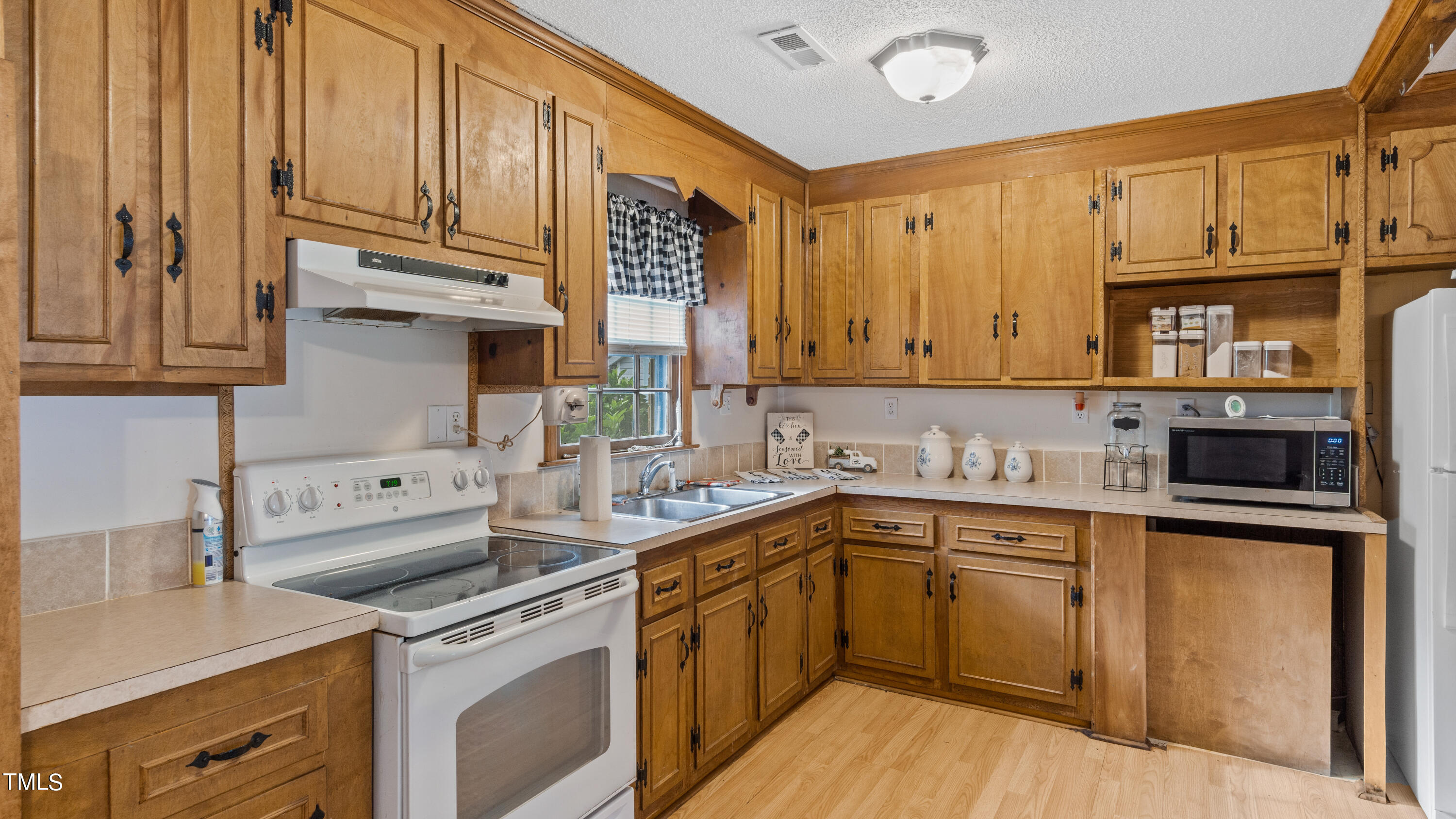 125 Walter Street Manson, NC 27553 - Photo 8 of 39 a kitchen with stainless steel appliances granite countertop a sink stove and refrigerator