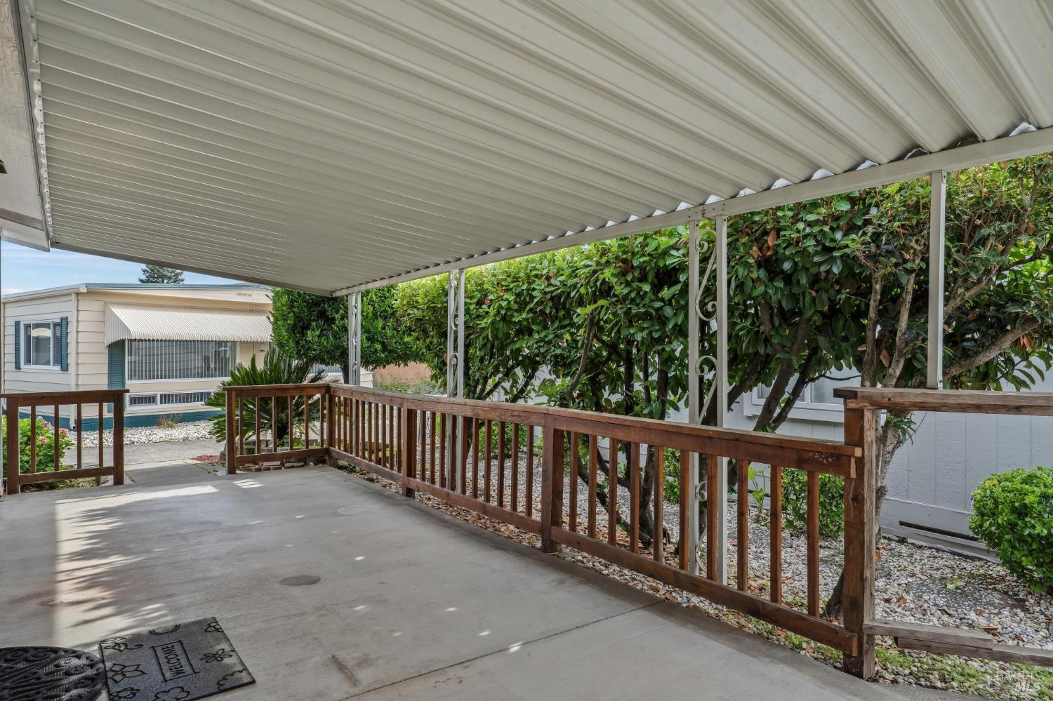 109 Merida Drive Sonoma, CA 95476 - Photo 2 of 20 a view of a patio with table and chairs under an umbrella with a small yard