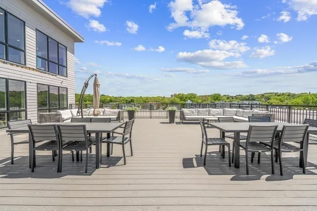 a view of a patio with table and chairs
