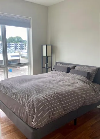 a large bed sitting in a bedroom next to a window