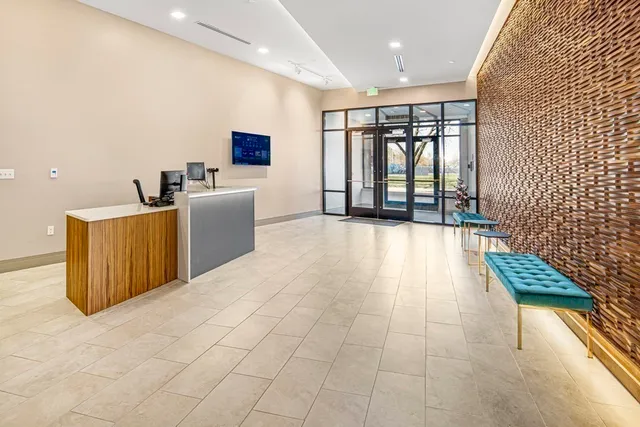 a view of a living room with furniture and a flat screen tv