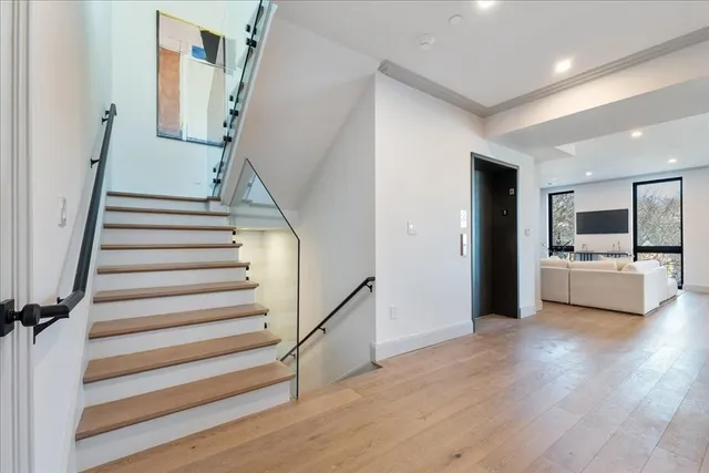 a view of a hallway with kitchen and entryway