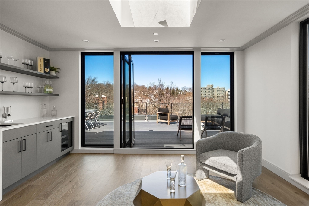 57 University Road, Unit PH Brookline, MA 02445 - Photo 16 of 23 a living room with furniture and a large window