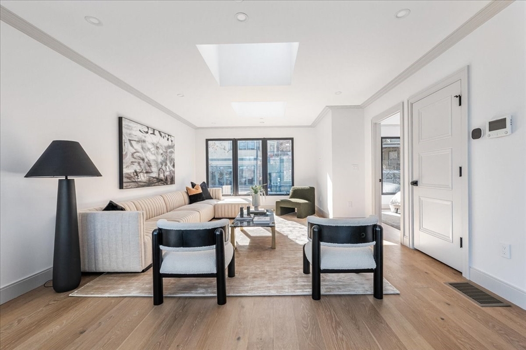 57 University Road, Unit PH Brookline, MA 02445 - Photo 17 of 23 a living room with furniture and a wooden floor