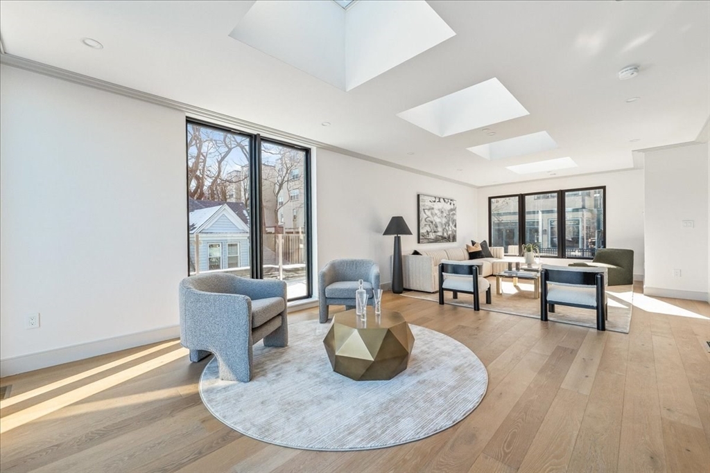 57 University Road, Unit PH Brookline, MA 02445 - Photo 19 of 23 a living room with furniture and a wooden floor