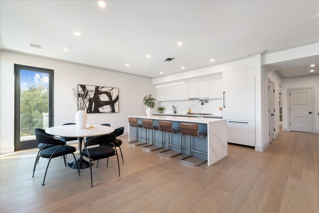 57 University Road, Unit PH Brookline, MA 02445 - Photo 3 of 23 a kitchen with a table and chairs in it