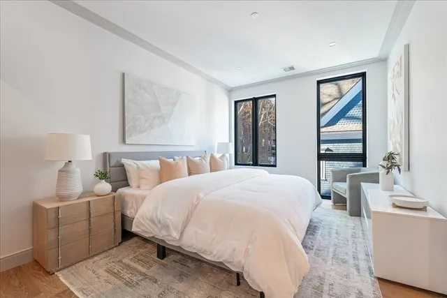 a bedroom with a large bed and a window