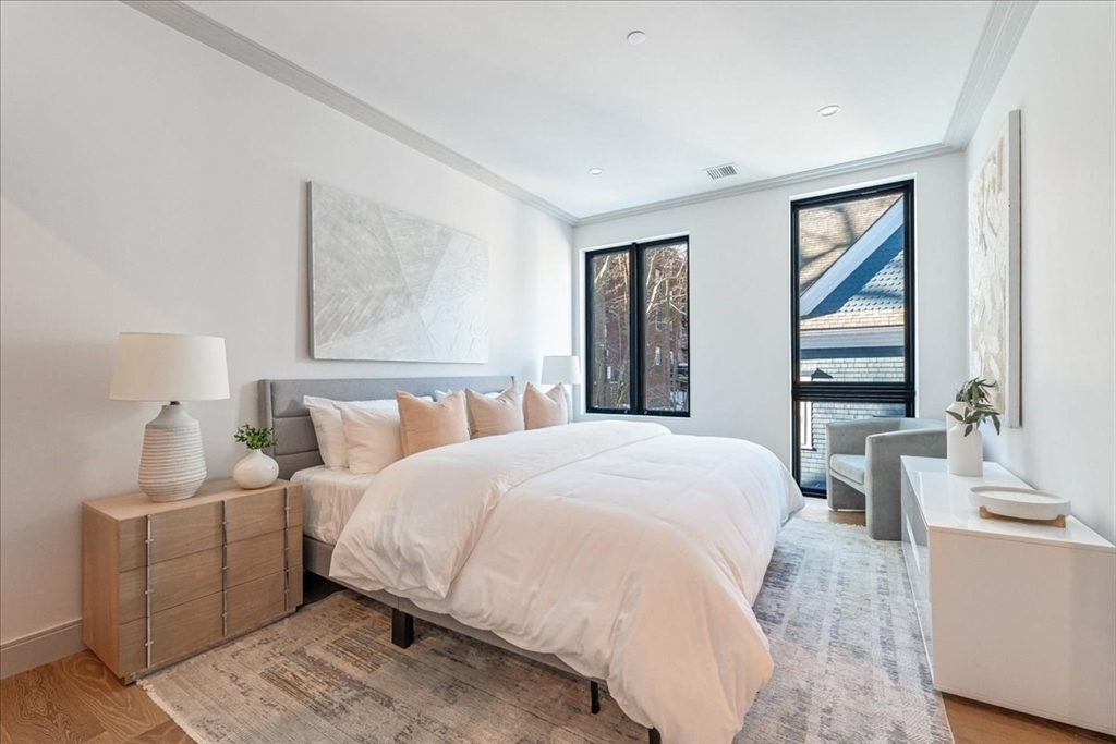 57 University Road, Unit PH Brookline, MA 02445 - Photo 8 of 23 a bedroom with a large bed and a window