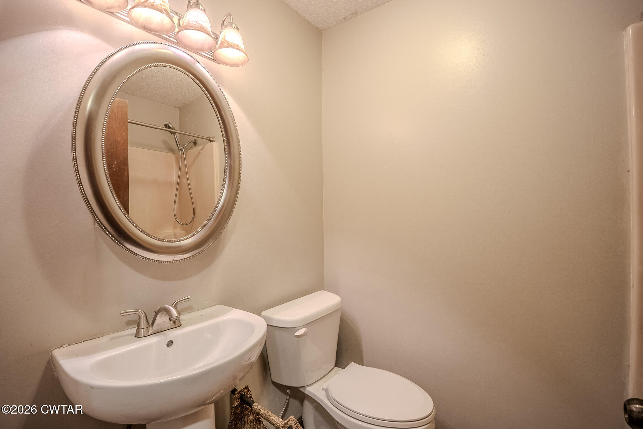 3559 Union Mercer Road Brownsville, TN 38012 - Photo 15 of 24 a bathroom with a toilet a sink and a mirror