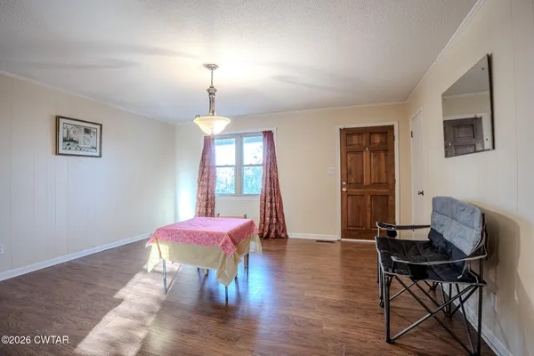 a dining room with furniture and window