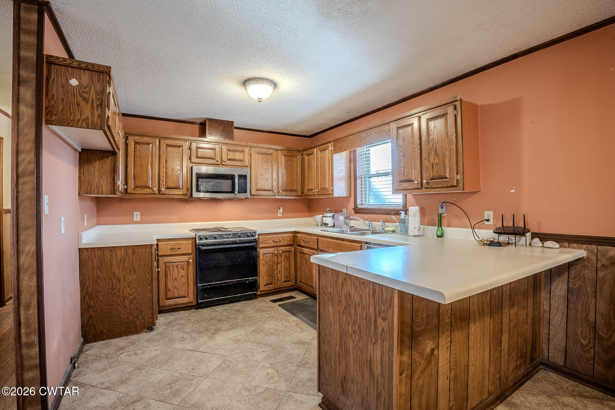 3559 Union Mercer Road Brownsville, TN 38012 - Photo 6 of 24 a kitchen with stainless steel appliances granite countertop a sink stove and refrigerator