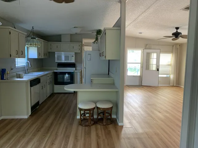 an empty room with fan and entrance