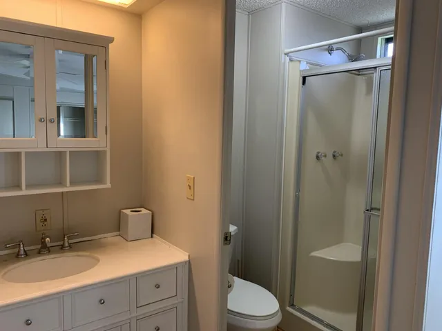 a view of a big room with closet and chandelier fan