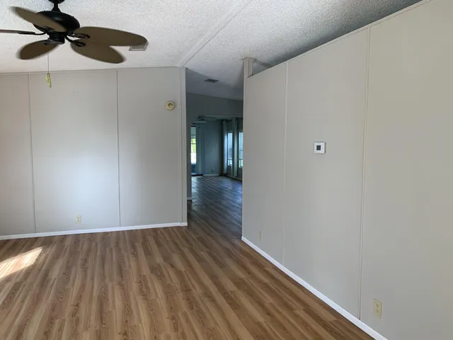 a view of empty room with wooden floor