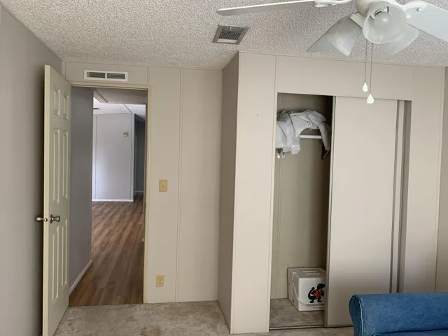 a view of a hallway with a livingroom and a hallway