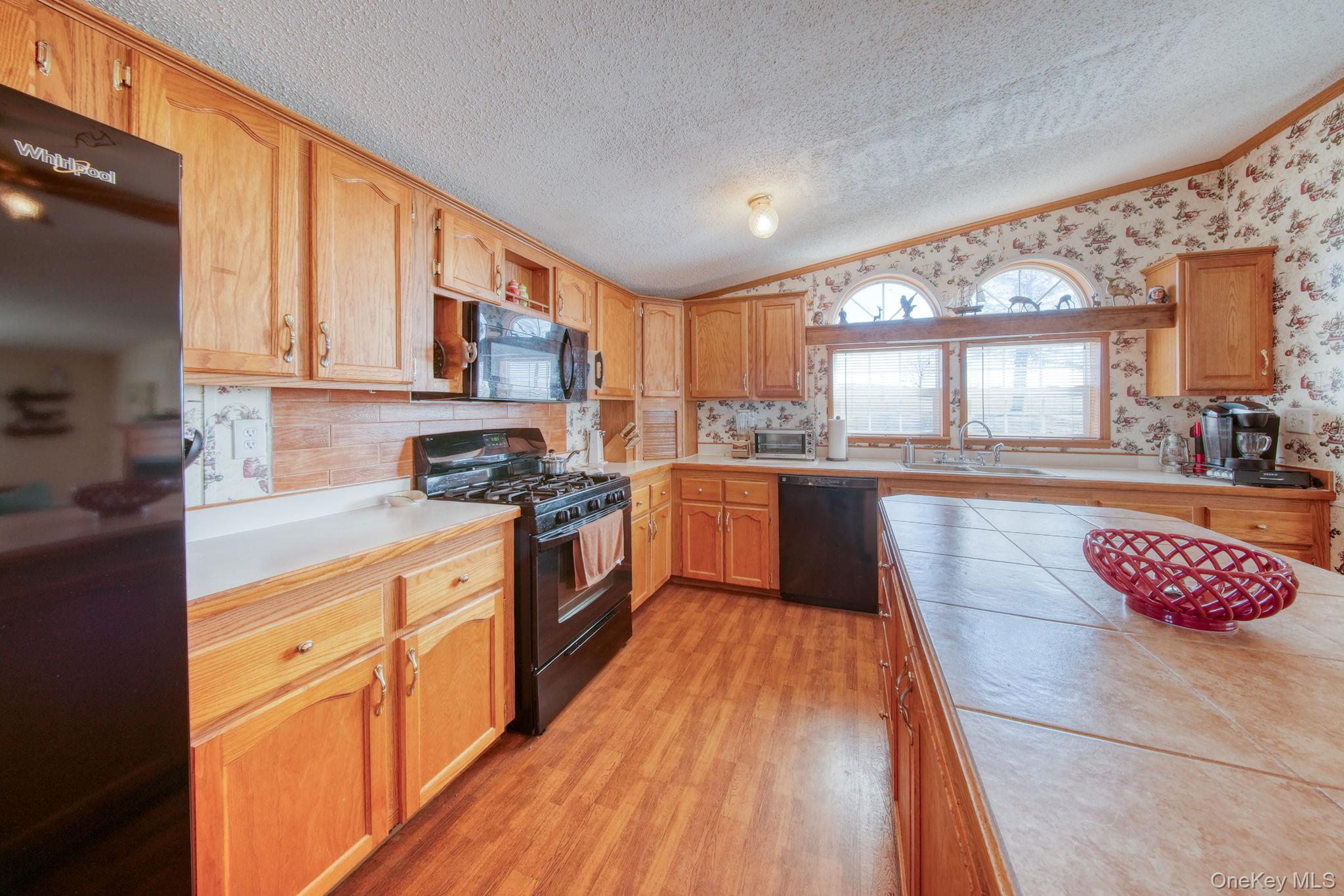 221 Gabel Road Callicoon, NY 12723 - Photo 11 of 44 a kitchen with stainless steel appliances granite countertop a stove a sink dishwasher and a microwave oven with cabinets