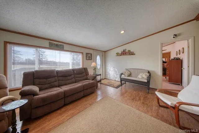 a living room with furniture wooden floor and a flat screen tv