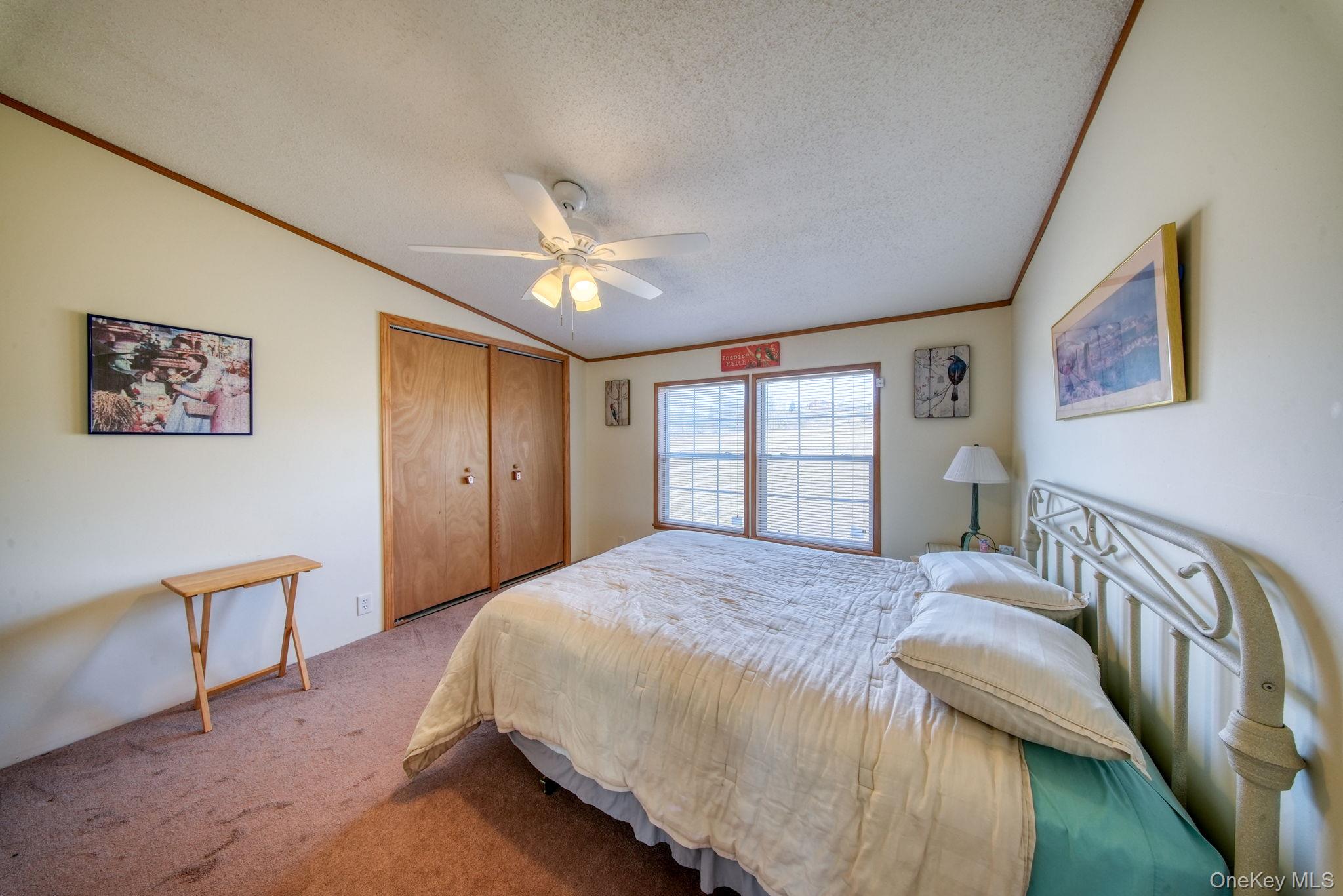 221 Gabel Road Callicoon, NY 12723 - Photo 30 of 44 a bedroom with a large bed and a chandelier