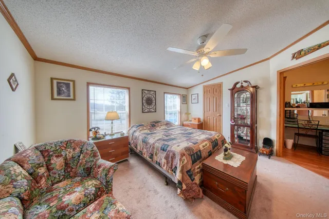 a bedroom with a bed and dresser with mirror